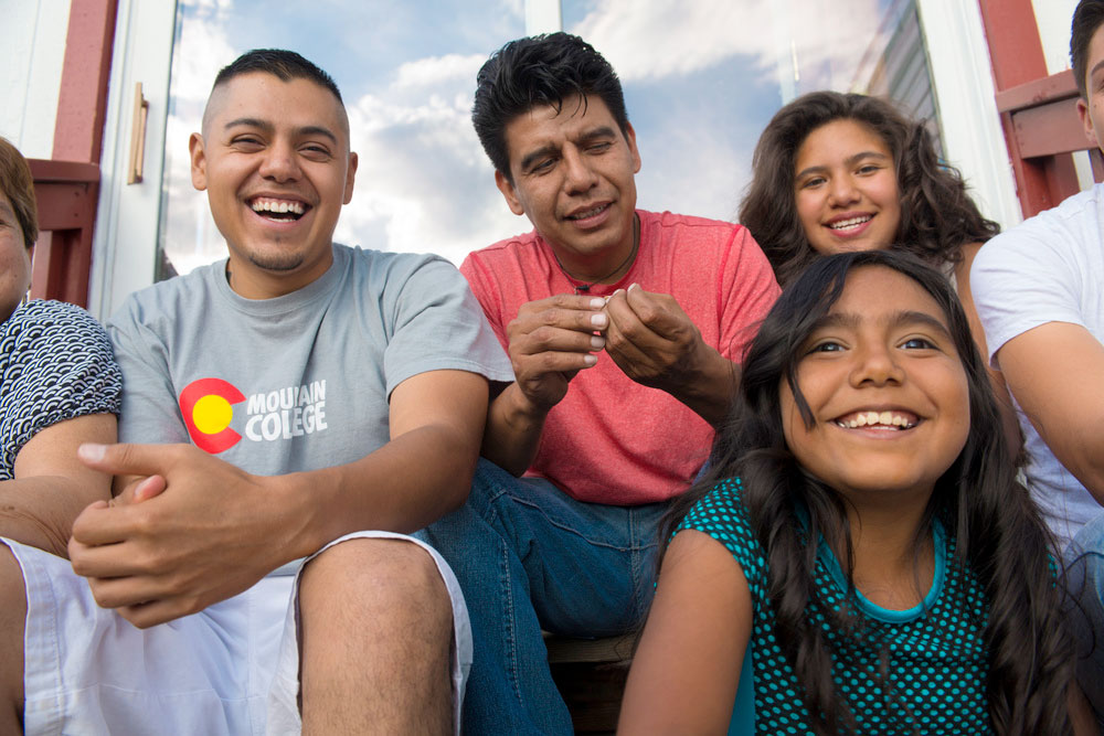 photo - William Mundo sitting with his family.